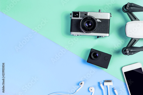 Hi tech travel gadget and accessories on blue and green copy space photo