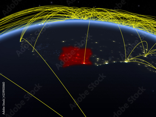 Ivory Coast on planet Earth at night with international network representing communication, travel and connections. photo