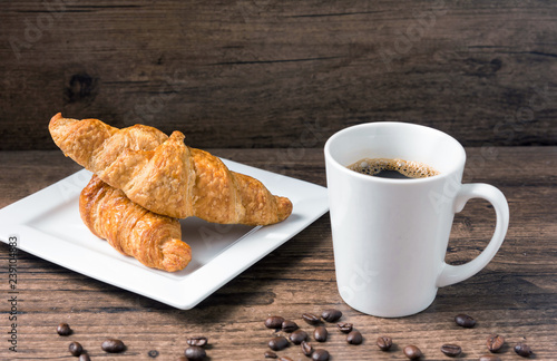 coffee break, White coffee cup, croissants on wood table background, selective focus. Breakfast concept