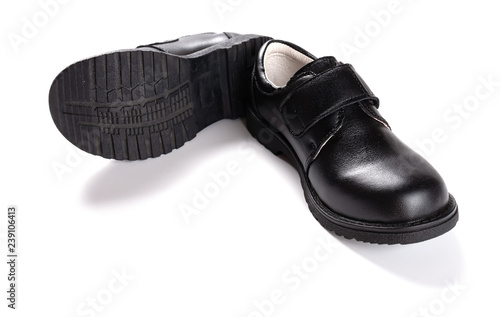 pair of brand new black leather shoe for children on white background