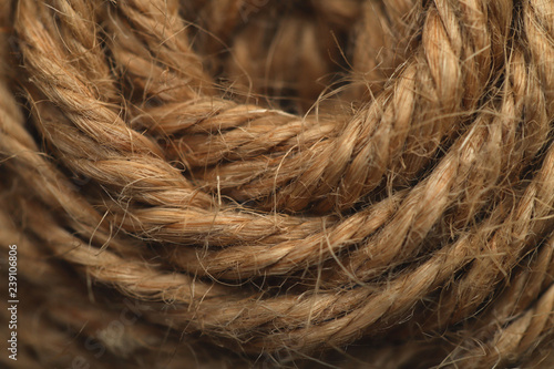 Background texture of a semicircle of a hemp of natural hemp rope. Cropped shot  close-up  horizontal  abstract.