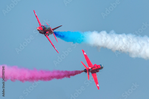 Acrobat with blue and red smoke