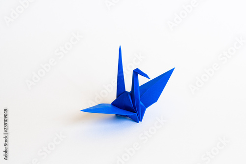 blue Origami crane on white background