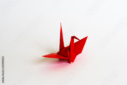 red Origami crane on white background