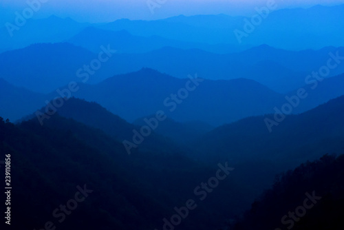 Layers of blue color mountains during sunset