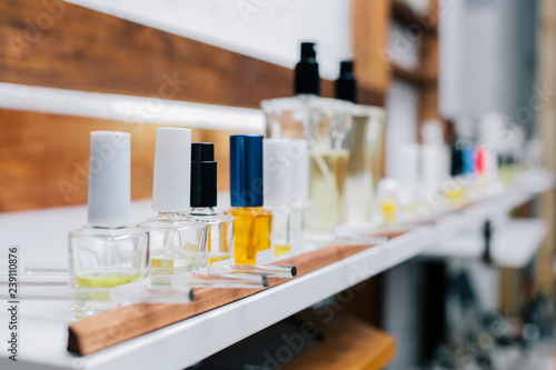 Close up amber color bottles on the shelf in old perfume laboratory. Flasks and examples of odor in the perfume shop.