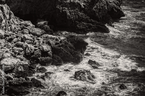 Waves hitting Rocks in Black and White