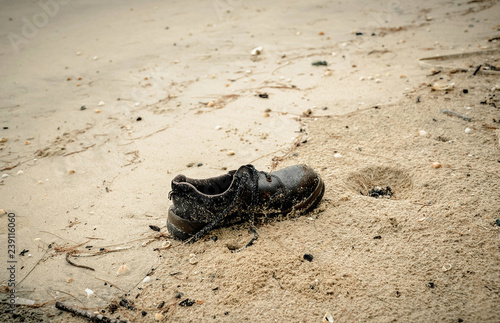 shoes garbage the beach   sea water pollution with old shoes save the earth