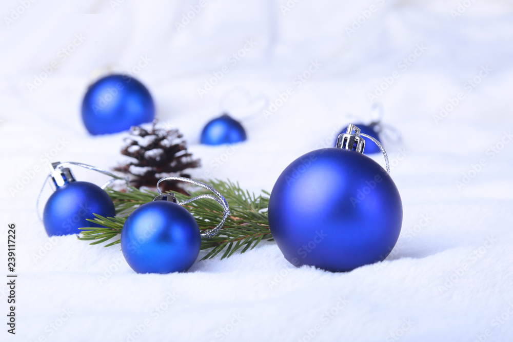 Merry Christmas background with blue balls, christmas tree on snow with snowflakes falling from a blue sky. Merry Christmas background with blue balls, christmas tree on snow with snowflakes falling from a blue sky.
