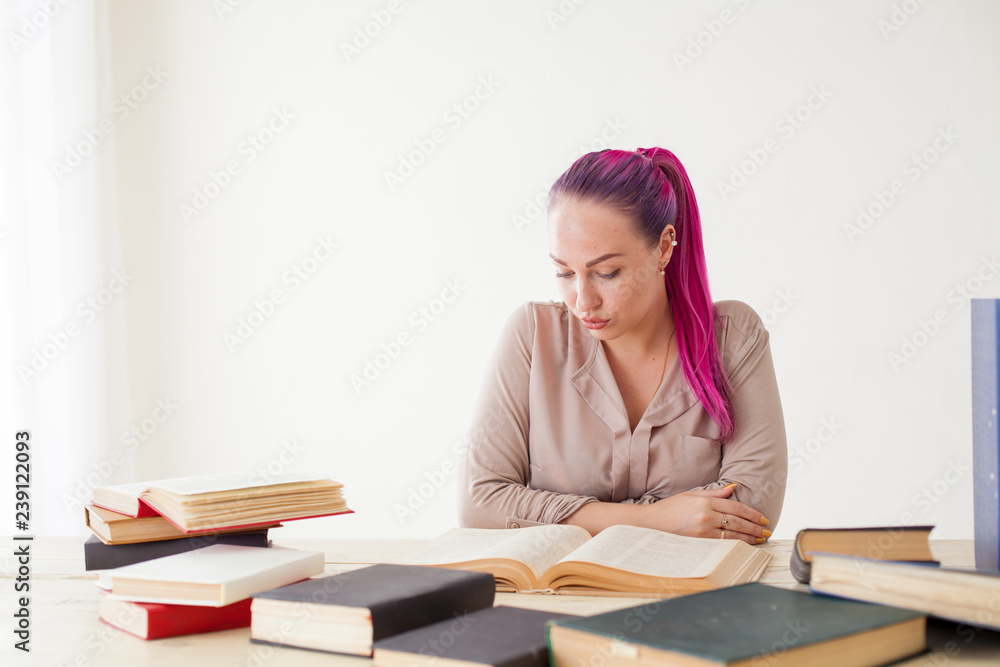 beautiful business woman working in an Office behind a table with books beautiful business woman working in an Office behind a table with books