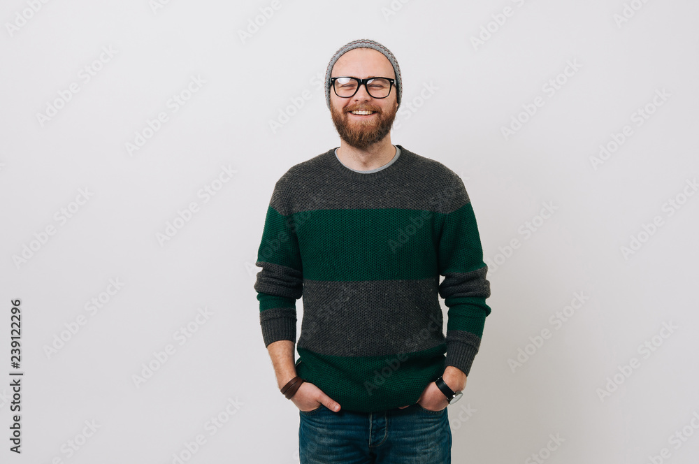 Smiling bearded hipster man wearing pullover over white backgorund Smiling bearded hipster man wearing pullover over white backgorund