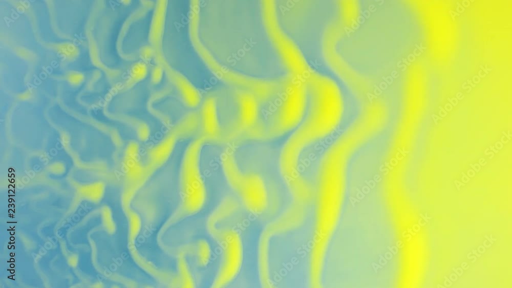 Wind forms beautiful waves of yellow paint on a blue background. Abstract colorful background. Wind forms beautiful waves of yellow paint on a blue background. Abstract colorful background.