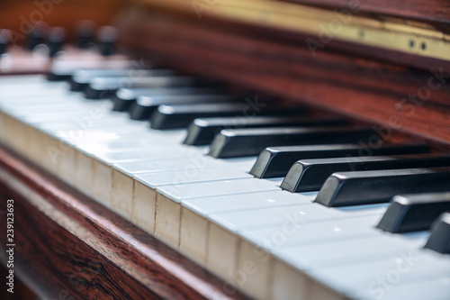 Closeup image of a vintage wooden grand piano