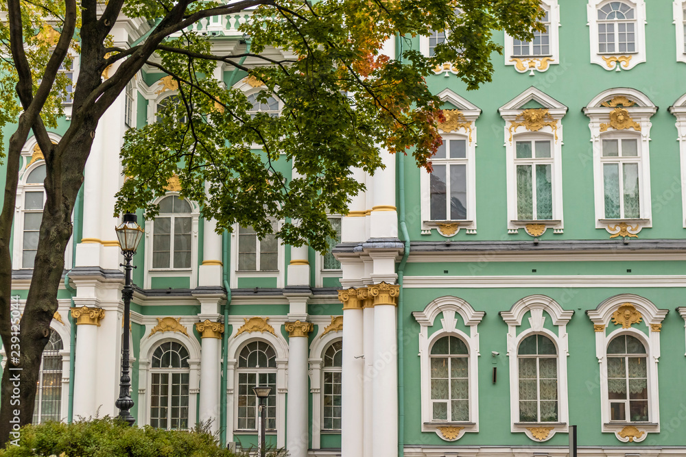 Obraz premium Green old building facade on a restored majestic russian building