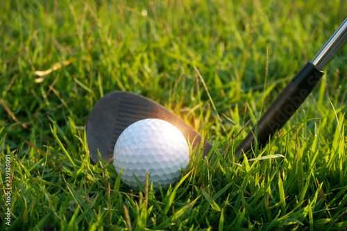 Golf ball and golf club in beautiful golf course with sunset background. Golf ball on green in golf course at Thailand
