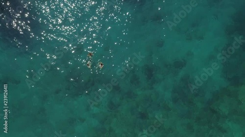 Aerial view of people in ferry diving on the sea, Ithaki island, Greece. photo