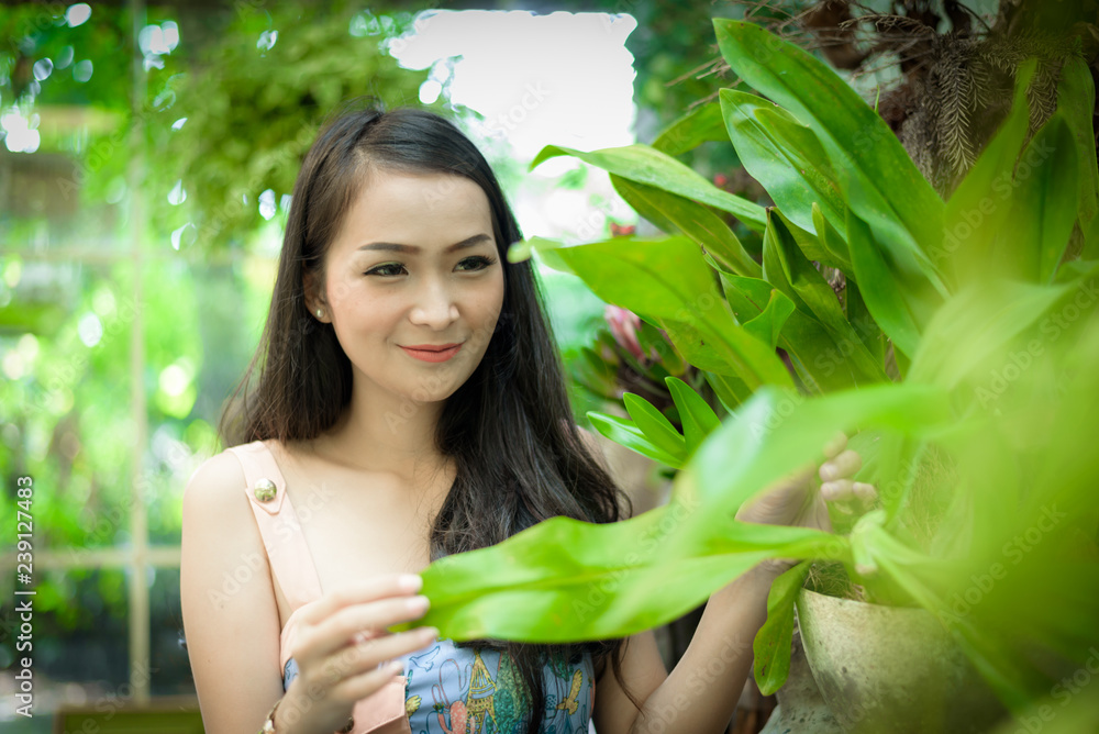 Asian pretty girl has relaxing with happy and smiling at Little Tree Garden cafe, Nakhon Pathom province, Thailand in the morning. Asian pretty girl has relaxing with happy and smiling at Little Tree Garden cafe, Nakhon Pathom province, Thailand in the morning.