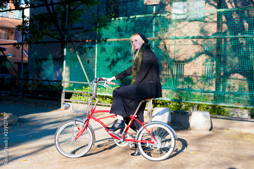 Caucasian female model poses for pictures on the street