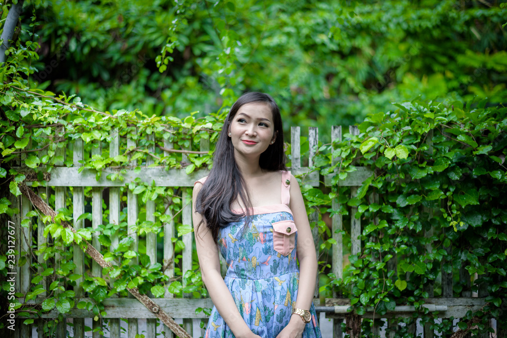 Asian pretty girl has relaxing with happy and smiling at Little Tree Garden cafe, Nakhon Pathom province, Thailand in the morning. Asian pretty girl has relaxing with happy and smiling at Little Tree Garden cafe, Nakhon Pathom province, Thailand in the morning.