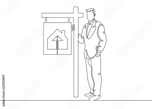 realtor stands in the signboards of a poster selling a cottage house