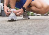 sport runner prepare for a run with shoes and smart watch for run monitoring