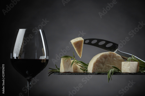 Sheep cheese with rosemary and glass of red wine.