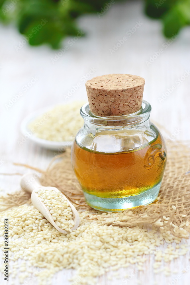 Sesame oil in glass and seeds Sesame oil in glass and seeds