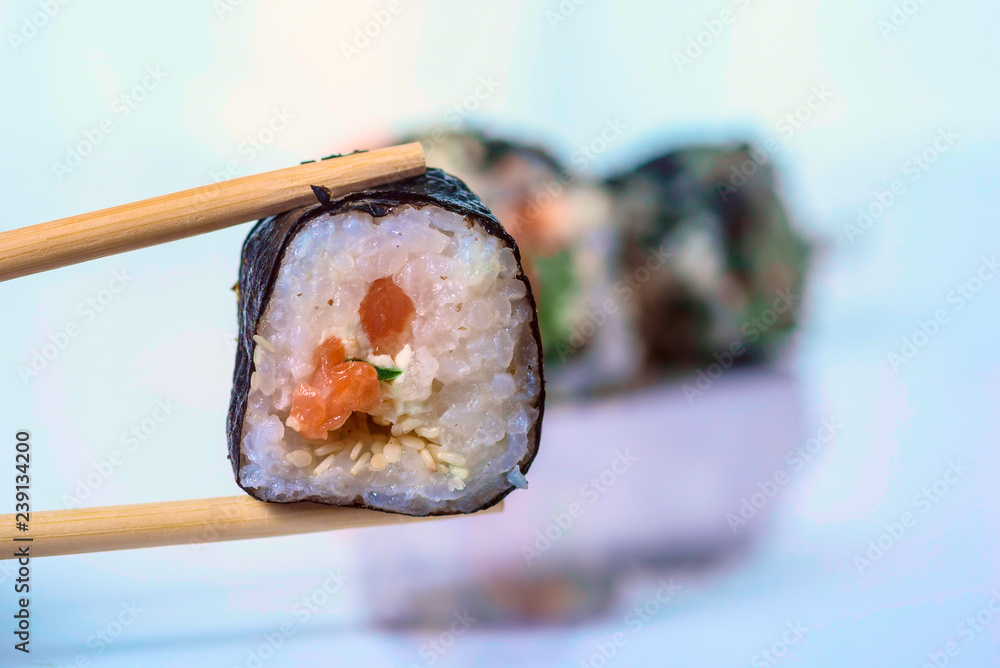 Holds roll-sushi sticks. Photographed close-up. Holds roll-sushi sticks. Photographed close-up.