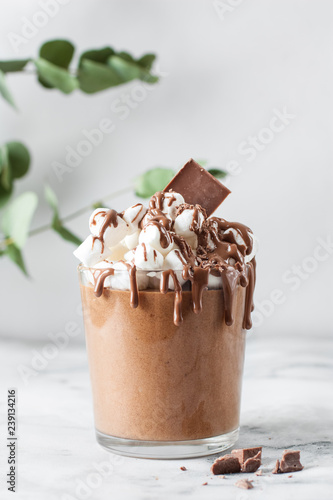 Chocolate mousse in a glasses on a marble background