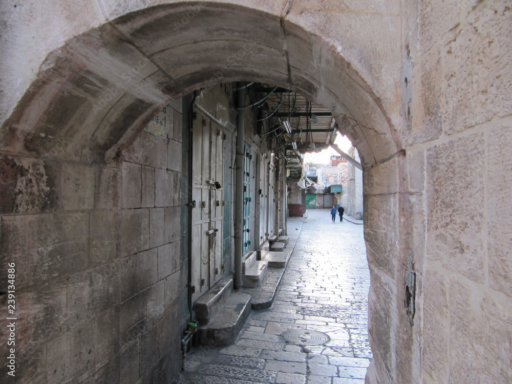 View of unfrequented street in the center of Jerusalem through the arch
