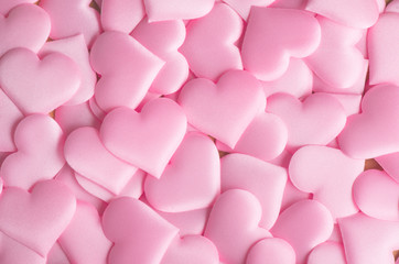 Valentine's Day. Pink heart shape backdrop. Abstract holiday Valentine background with pink satin hearts. Love concept. Flat lay, top view