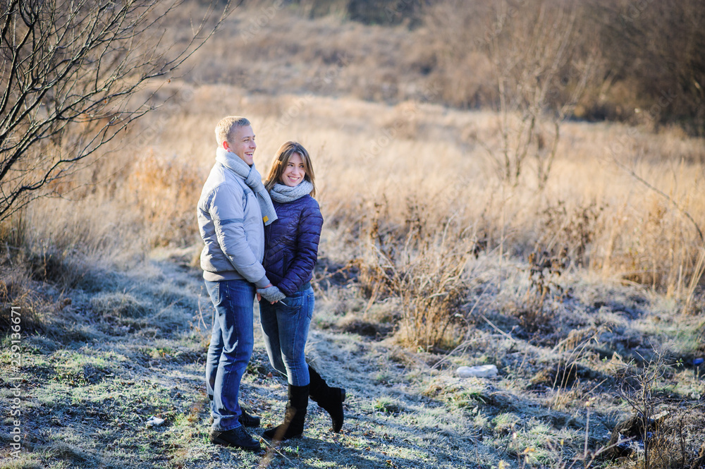 outdoor fashion portrait of young sensual couple in cold winter wather. love and kiss outdoor fashion portrait of young sensual couple in cold winter wather. love and kiss