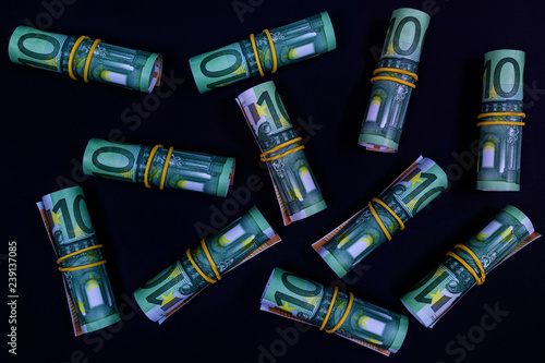 rolled one hundred euro on a black background