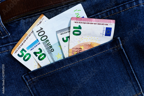 euro bills sticking out of the back jeans pocket