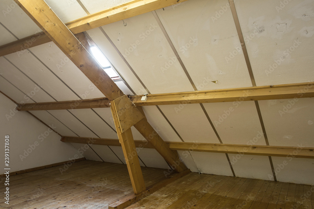 Obraz premium Attic, roof before construction with window and wooden beams