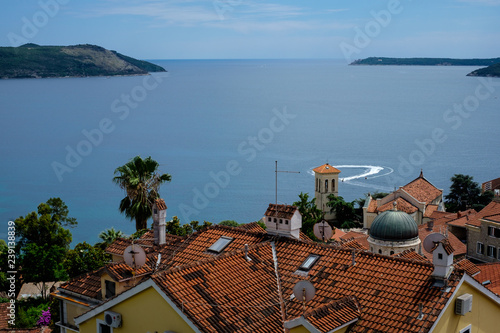 tiled roofs and cruise ship on background of the mountains in Montenegro