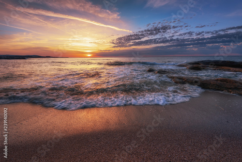 Seascape during sunrise. Beautiful natural seascape. Sea sunrise at the Black Sea coast. Magnificent sunrise with clouds and fire sun at the beginning of April.Ravda, Bulgaria