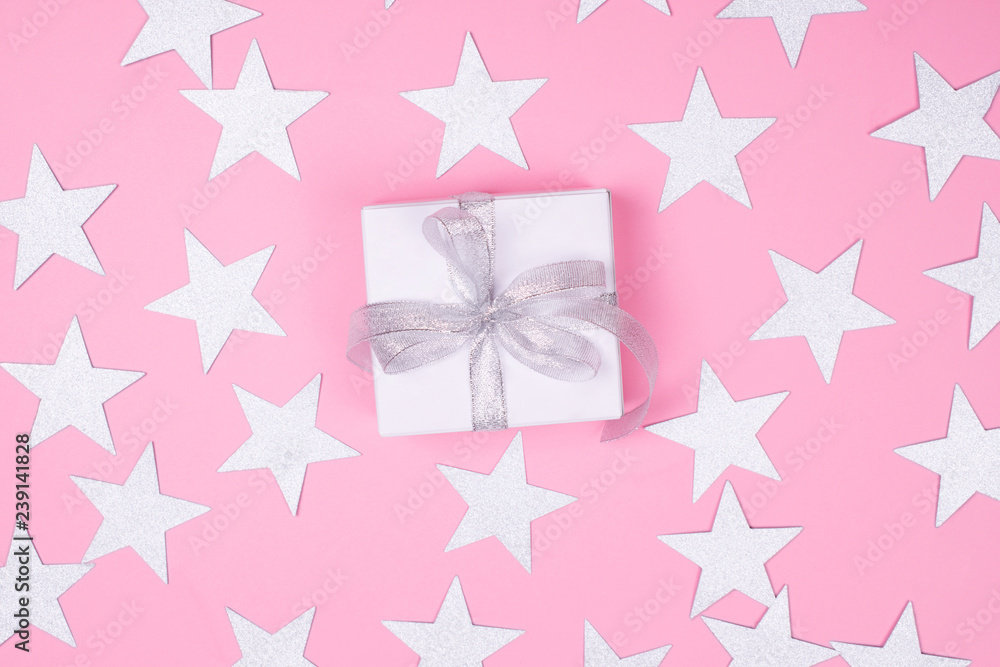 White gift box on pink background.