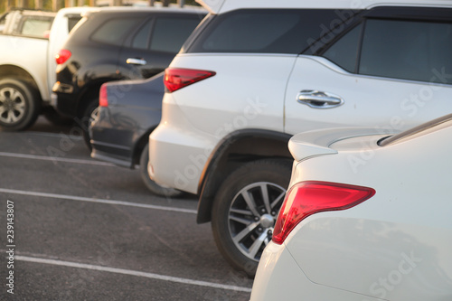 Closeup of rear side of white car parking in parking lot. © Amphon