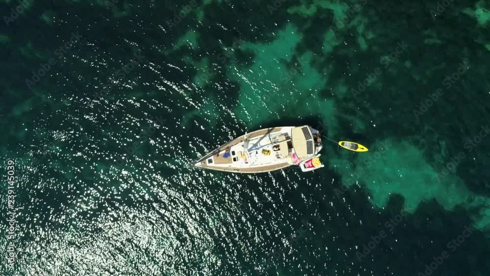 Aerial view above sailboat swinging on the coast of Varko, Greece. Aerial view above sailboat swinging on the coast of Varko, Greece.