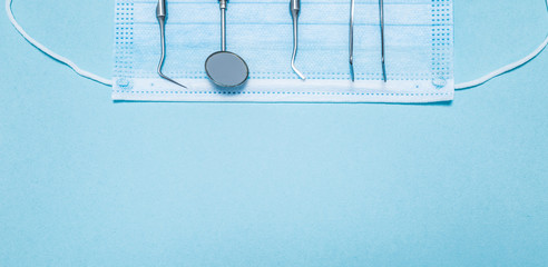 Dental tool on a blue background. Dentist instrument. Copy space. 