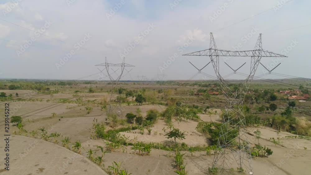 Electricity pylons bearing power supply across rural landscape. aerial ...