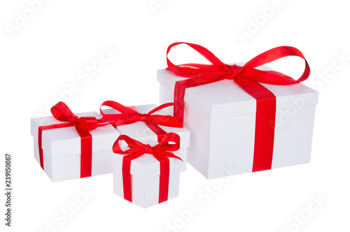 Fototapeta Naklejka Na Ścianę i Meble -  Stack of presents white gifts ribbon red bow isolated on white background