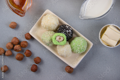 Fat keto peanut butter, cheesecake, matcha coconut balls . keto protein balls and matcha tea recipes ingredients. it works ketogenic diet. gray background photo