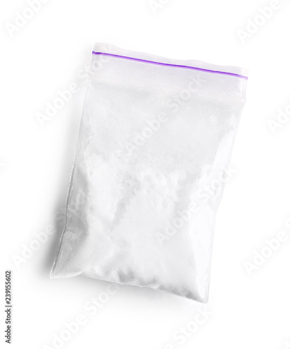 Фотография Cocaine in plastic bag on white background, top view