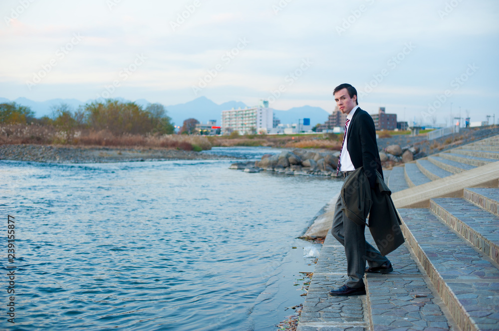 Caucasian male model poses for pictures on the street