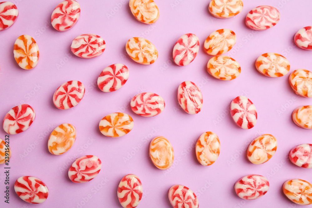 Flat lay composition with delicious colorful candies on color background Flat lay composition with delicious colorful candies on color background