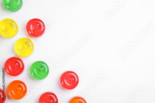 Delicious colorful candies on white background, top view