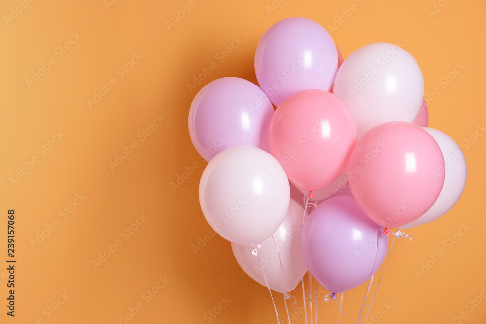 Different helium party balloons on color background. Space for text Different helium party balloons on color background. Space for text