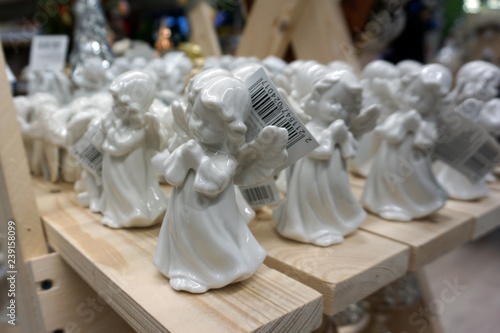 Decorative porcelain figures of little angels at Christmas market. Traditional market with handmade souvenirs © MishaelPervak